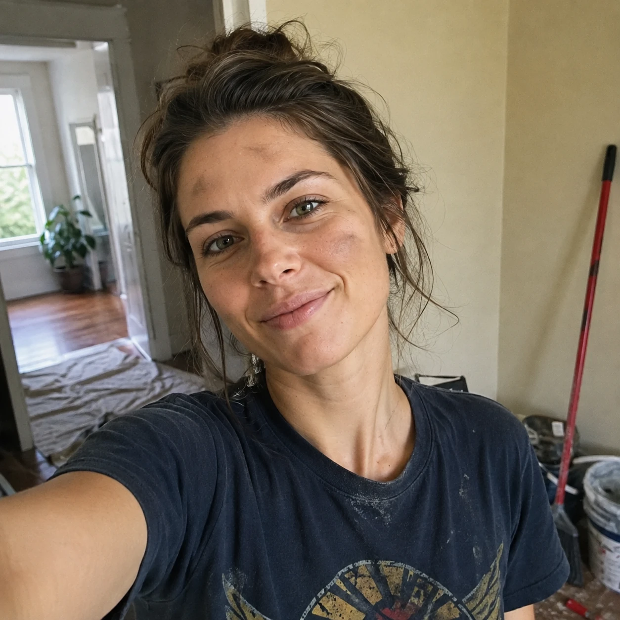 Selfie of Theresa Sterling, looks like she has just finished painting her living room. stripes on her forehead.